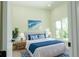Cozy bedroom with a queen bed adorned with blue and white bedding, complemented by matching décor at 12484 Cross St, Largo, FL 33773