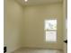 Bright bedroom featuring a window with natural light, neutral walls, and wood-look floors at 12484 Cross St, Largo, FL 33773
