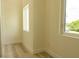 Bright room with two windows, painted walls and white door trim at 12484 Cross St, Largo, FL 33773