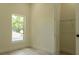 Bright bedroom featuring a window, neutral walls, and closet with wire shelving at 12484 Cross St, Largo, FL 33773