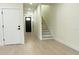 Inviting entryway with staircase, light wood floors, and neutral paint, providing a clean and modern aesthetic at 12484 Cross St, Largo, FL 33773