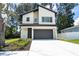 Modern two-story home featuring a gray garage door, well-manicured landscaping and a light-colored exterior at 12484 Cross St, Largo, FL 33773