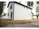 New construction home featuring a modern design with sliding glass door and minimal landscaping at 12484 Cross St, Largo, FL 33773