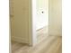 Hallway with light wood floors and neutral paint with white door trim at 12484 Cross St, Largo, FL 33773