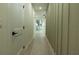 Long hallway featuring wood floors and modern decor with a view of the backyard at 12484 Cross St, Largo, FL 33773