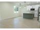 Bright kitchen and living room area with island, stainless steel appliances, and lots of natural light at 12484 Cross St, Largo, FL 33773