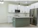 Modern kitchen with white cabinets, stainless steel appliances, and an island at 12484 Cross St, Largo, FL 33773