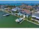 An aerial view showing the back of the home with pool, the private boat dock, and gulf access at 14 Sunset Bay Dr, Belleair, FL 33756
