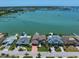 Stunning aerial view of waterfront homes with docks, boats, and scenic bay views at 14 Sunset Bay Dr, Belleair, FL 33756