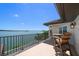 Enjoy stunning waterfront views from this balcony with table and chairs at 14 Sunset Bay Dr, Belleair, FL 33756