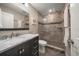 Stylish bathroom featuring modern vanity with marble countertop and glass-enclosed shower at 14 Sunset Bay Dr, Belleair, FL 33756