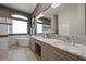 Luxurious bathroom featuring double sinks, granite countertops, and a soaking tub at 14 Sunset Bay Dr, Belleair, FL 33756
