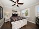 Bright bedroom with a decorative bed, natural light, and a hardwood floor at 14 Sunset Bay Dr, Belleair, FL 33756