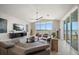 Open-concept living room with large windows offering panoramic waterfront views at 14 Sunset Bay Dr, Belleair, FL 33756