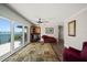 Comfortable living room featuring balcony access with water view, wet bar, and rich decor at 14 Sunset Bay Dr, Belleair, FL 33756