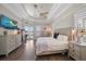 Relaxing bedroom suite with wood floors, tray ceiling and an outdoor patio at 14 Sunset Bay Dr, Belleair, FL 33756