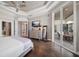 Bedroom featuring tray ceilings, and access to a private outdoor patio at 14 Sunset Bay Dr, Belleair, FL 33756