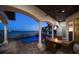 Inviting waterfront patio with fire pit and comfortable seating; beautiful pool view at 14 Sunset Bay Dr, Belleair, FL 33756