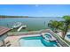 Gorgeous waterfront pool and spa with spacious patio and dock; perfect for entertaining at 14 Sunset Bay Dr, Belleair, FL 33756