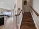 Beautiful staircase with wood treads and white risers leading to second level at 14 Sunset Bay Dr, Belleair, FL 33756