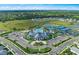Aerial view of community clubhouse, pool, tennis courts and surrounding neighborhood within the Talon Preserve community at 14313 Eagle Branch Dr, Nokomis, FL 34275