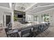 Clubhouse bar with granite counters, modern lighting, full bar and seating for residents at 14313 Eagle Branch Dr, Nokomis, FL 34275