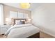 Bedroom featuring white walls, a white bedspread, bedside tables, and a wicker light fixture at 14313 Eagle Branch Dr, Nokomis, FL 34275