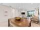 Dining area features a wooden table, stylish chandelier, and views of the adjacent living space at 14313 Eagle Branch Dr, Nokomis, FL 34275