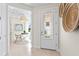 Welcoming entryway showcases stylish decor, a glass-paneled front door, and leads to a bright office space at 14313 Eagle Branch Dr, Nokomis, FL 34275