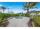 Community hot tub area surrounded by lush landscaping, providing a serene relaxation space at 14313 Eagle Branch Dr, Nokomis, FL 34275