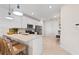 Modern kitchen featuring a spacious island with bar seating, stainless steel appliances, and white cabinets at 14313 Eagle Branch Dr, Nokomis, FL 34275