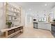 Modern kitchen with stainless steel appliances, kitchen island, and open shelving at 14313 Eagle Branch Dr, Nokomis, FL 34275
