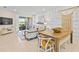 Open living area with a sliding glass door, comfortable seating, and stylish decor with a shiplap accent wall at 14313 Eagle Branch Dr, Nokomis, FL 34275