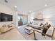 Inviting living room features a sliding door, plush seating, TV, and stylish decor for a comfortable gathering space at 14313 Eagle Branch Dr, Nokomis, FL 34275