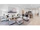 Open-concept living room with sleek furniture, stylish decor, and a seamless connection to the dining area at 14313 Eagle Branch Dr, Nokomis, FL 34275