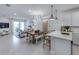Bright open-concept living space featuring modern kitchen, dining area, and living room with outdoor access at 14313 Eagle Branch Dr, Nokomis, FL 34275