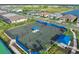 Aerial view of tennis court area surrounded by green landscape in Talon Preserve on Palmer Ranch at 14313 Eagle Branch Dr, Nokomis, FL 34275