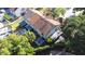 Aerial view of the backyard featuring a patio, lush landscaping, and proximity to a screened in pool at 16107 Dawnview Dr, Tampa, FL 33624