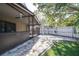 A well-maintained backyard featuring a screened patio, an artificial lawn, and a white fence at 16107 Dawnview Dr, Tampa, FL 33624