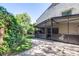 A spacious backyard featuring a screened patio, a lawn, and lush landscaping at 16107 Dawnview Dr, Tampa, FL 33624