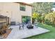 Backyard with artificial turf, patio, and outdoor seating under mature trees at 16107 Dawnview Dr, Tampa, FL 33624