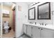 Bathroom featuring dual sink vanity and a separate room with toilet and shower at 16107 Dawnview Dr, Tampa, FL 33624