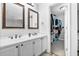 This bathroom features a double sink vanity and walk-in closet for optimal convenience at 16107 Dawnview Dr, Tampa, FL 33624