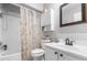Bathroom with a shower, tub, toilet, sink, and patterned shower curtain at 16107 Dawnview Dr, Tampa, FL 33624