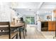Dining room and kitchen area featuring wood floors, a dining table, and sliding doors to the backyard at 16107 Dawnview Dr, Tampa, FL 33624