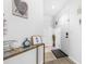 Bright entryway with white walls, a decorative table, and a view of the front door at 16107 Dawnview Dr, Tampa, FL 33624