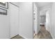 Hallway featuring a closet and an open doorway to a gray bedroom with 2 pictures at 16107 Dawnview Dr, Tampa, FL 33624