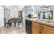 Kitchen and dining area showcasing wood cabinets, black appliances, and a dining table with seating at 16107 Dawnview Dr, Tampa, FL 33624