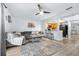 Spacious living room featuring a comfortable sectional sofa and an adjacent breakfast bar to the kitchen at 16107 Dawnview Dr, Tampa, FL 33624