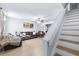 Bright living room featuring wood floors, a ceiling fan, comfortable seating and stairs to the upper level at 16107 Dawnview Dr, Tampa, FL 33624